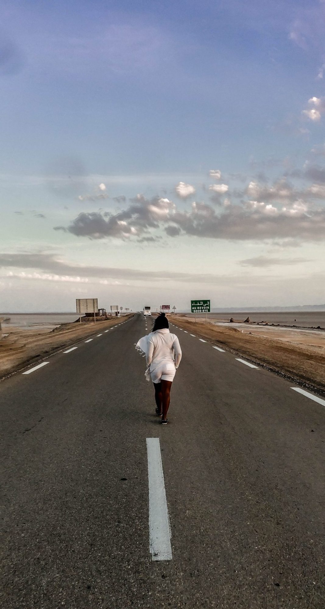 Walking the road between Tunisia and Algeria along the salt flats
