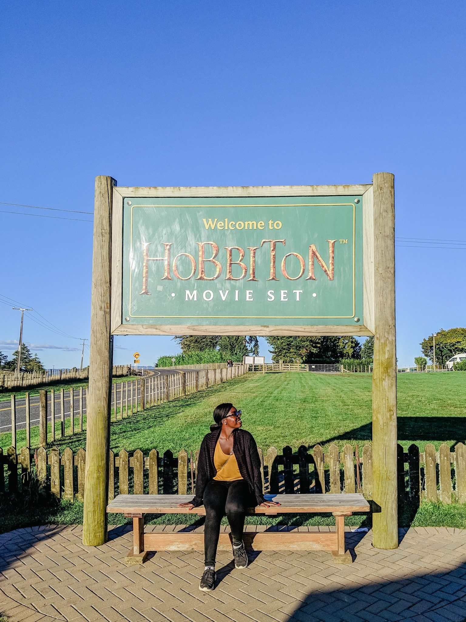 Taking a picture with the Hobbiton sign 