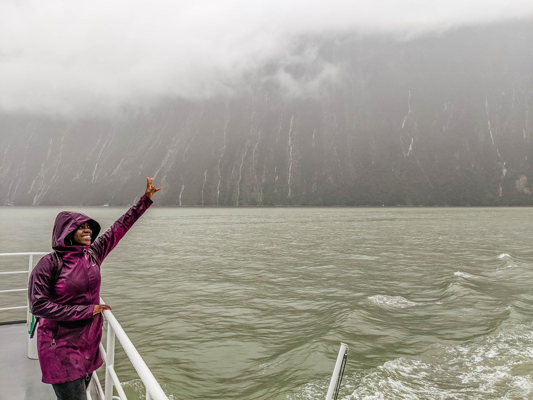 On the ferry ride in Milford Sound in New Zealand totally soaked from the rain