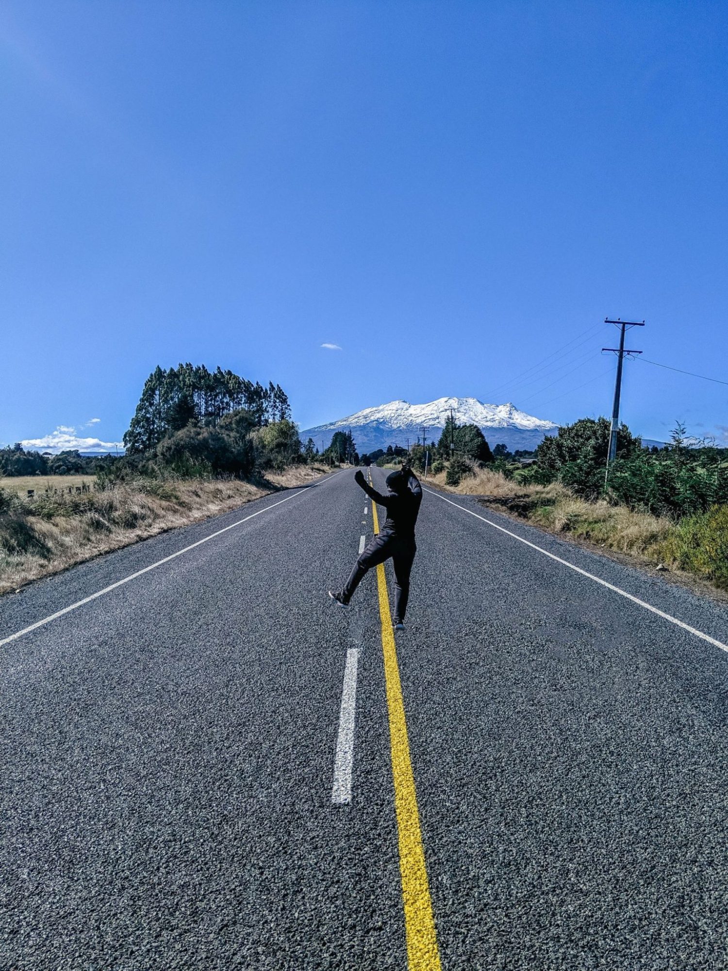 Jumping for joy in the middle of the road in New Zealand