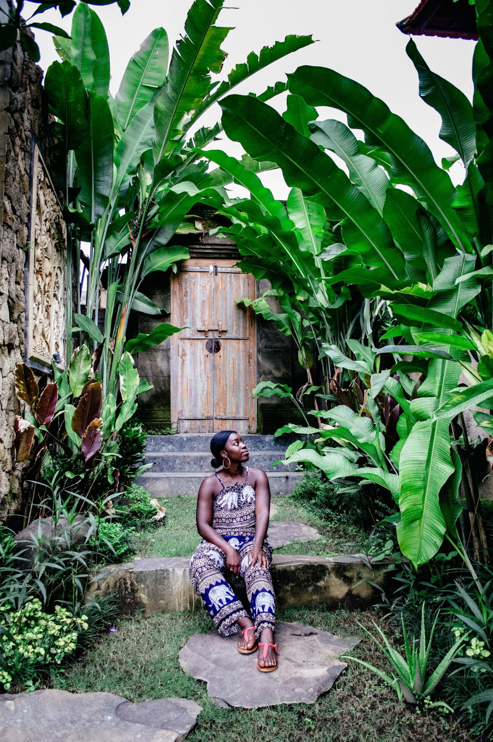 me by the beautiful lush green entrace to the villa in ubud