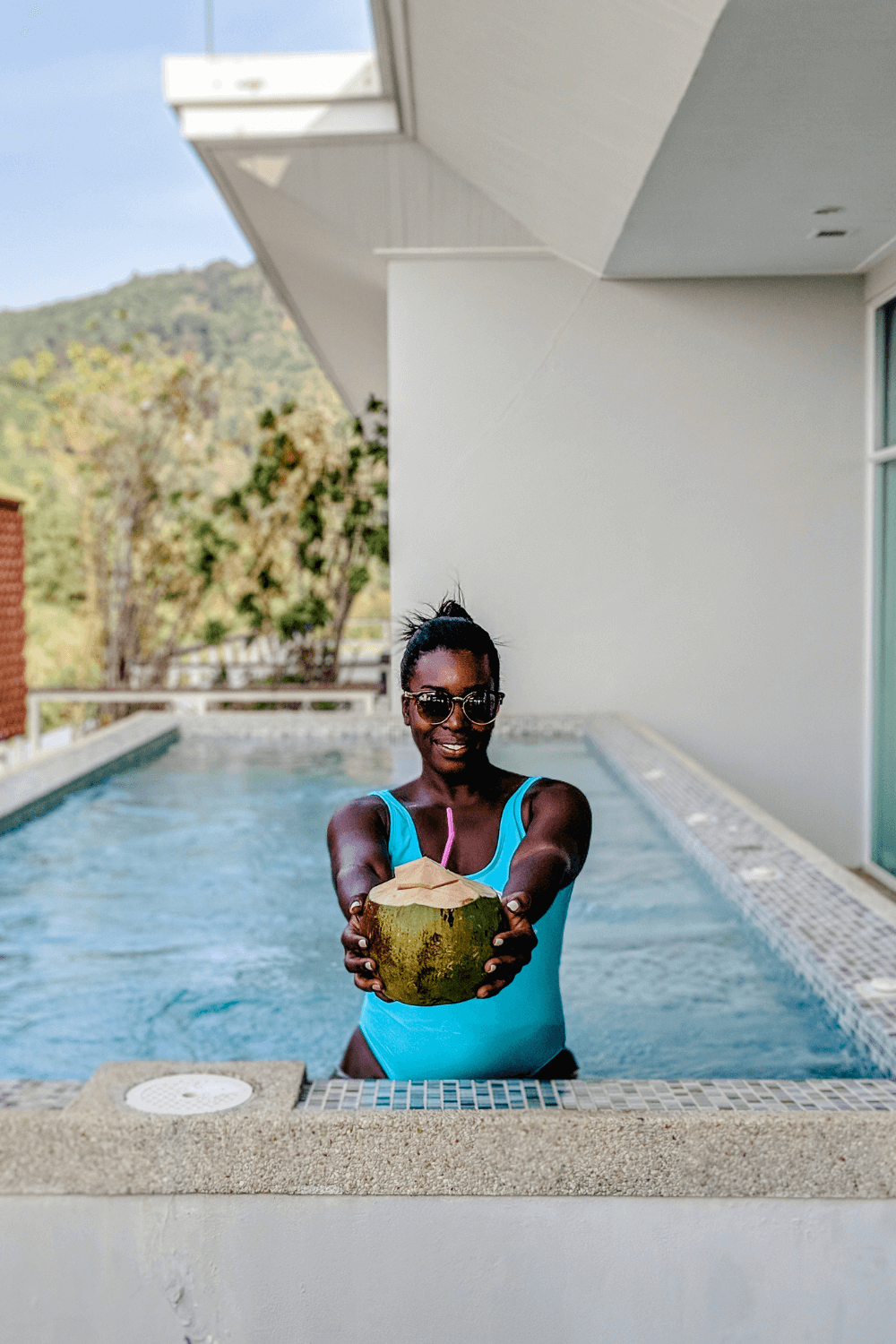 Shylo holding a coconut in the private pool in Phuket